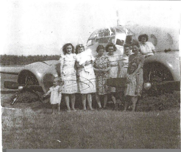 From the archives of Bonnie McGrath, Glenelg NS (with permission) Caption: Not sure of the names here. My Aunt Ella is on the front right (with the child in front of her). (This picture came from Elsie (Archibald) MacDonald). Photograph 1
